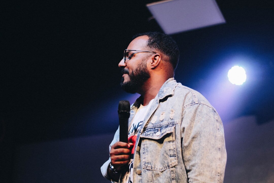 comedian on stage with microphone