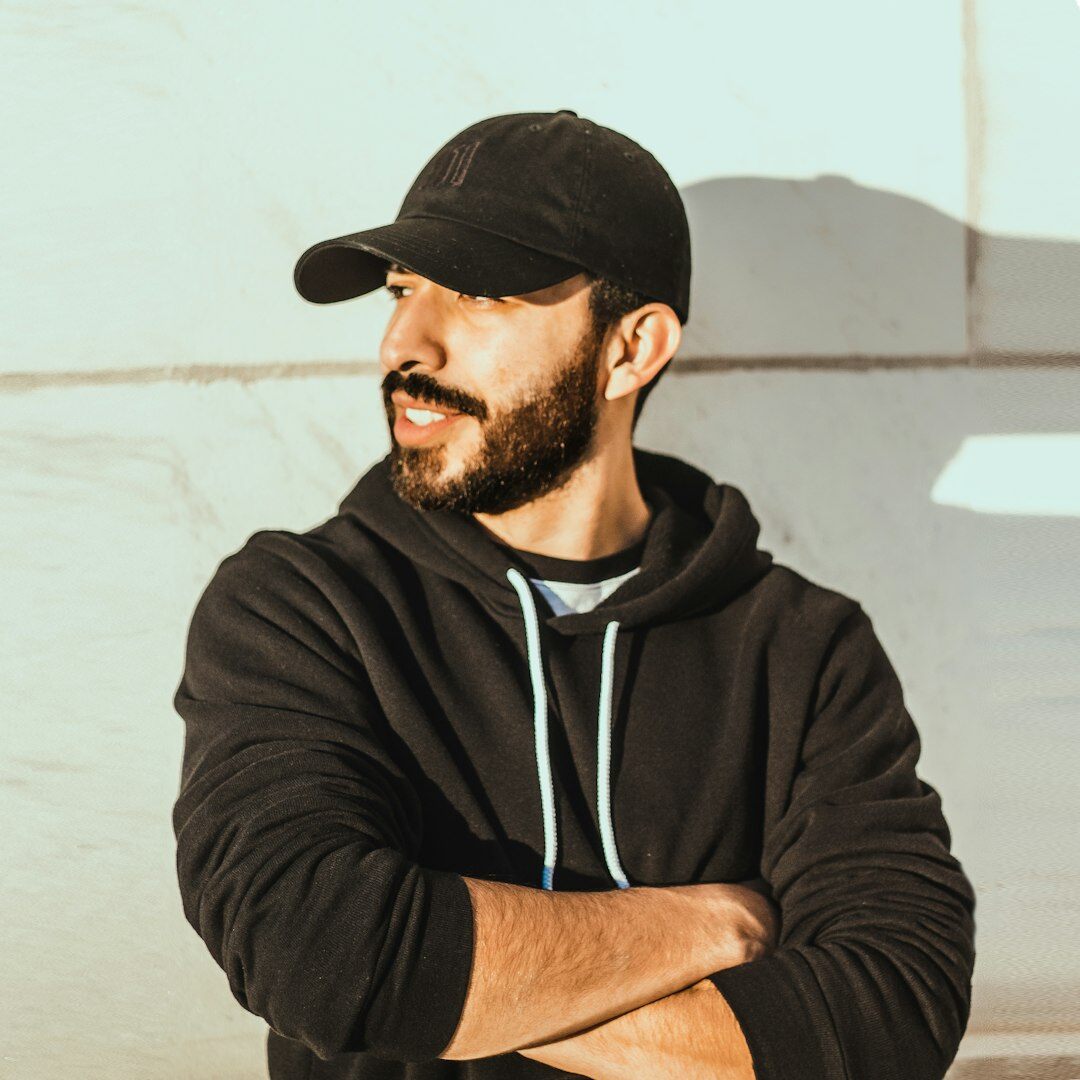 Bearded man wearing a hat posing for a portrait