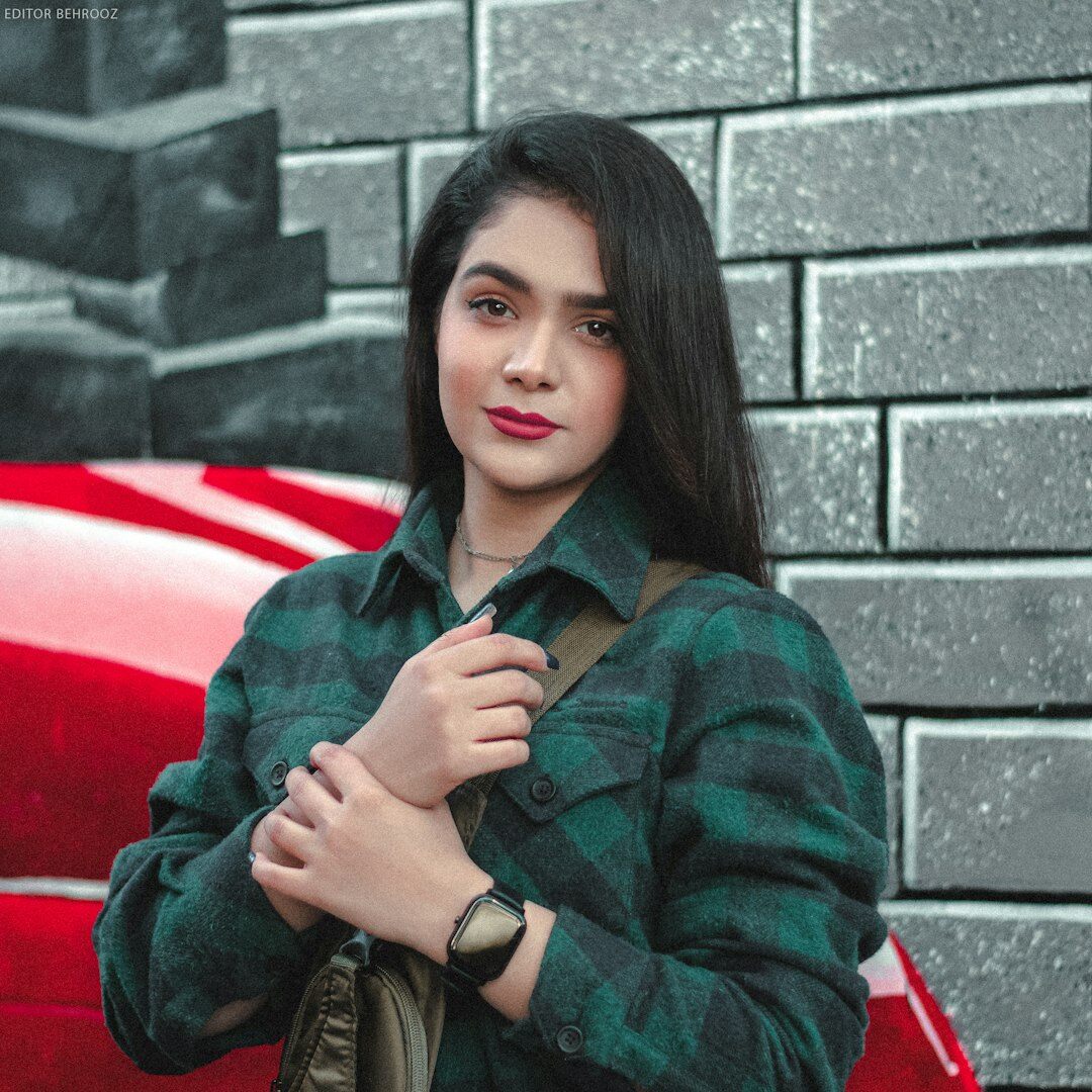 Woman in a checked shirt posing for a portrait