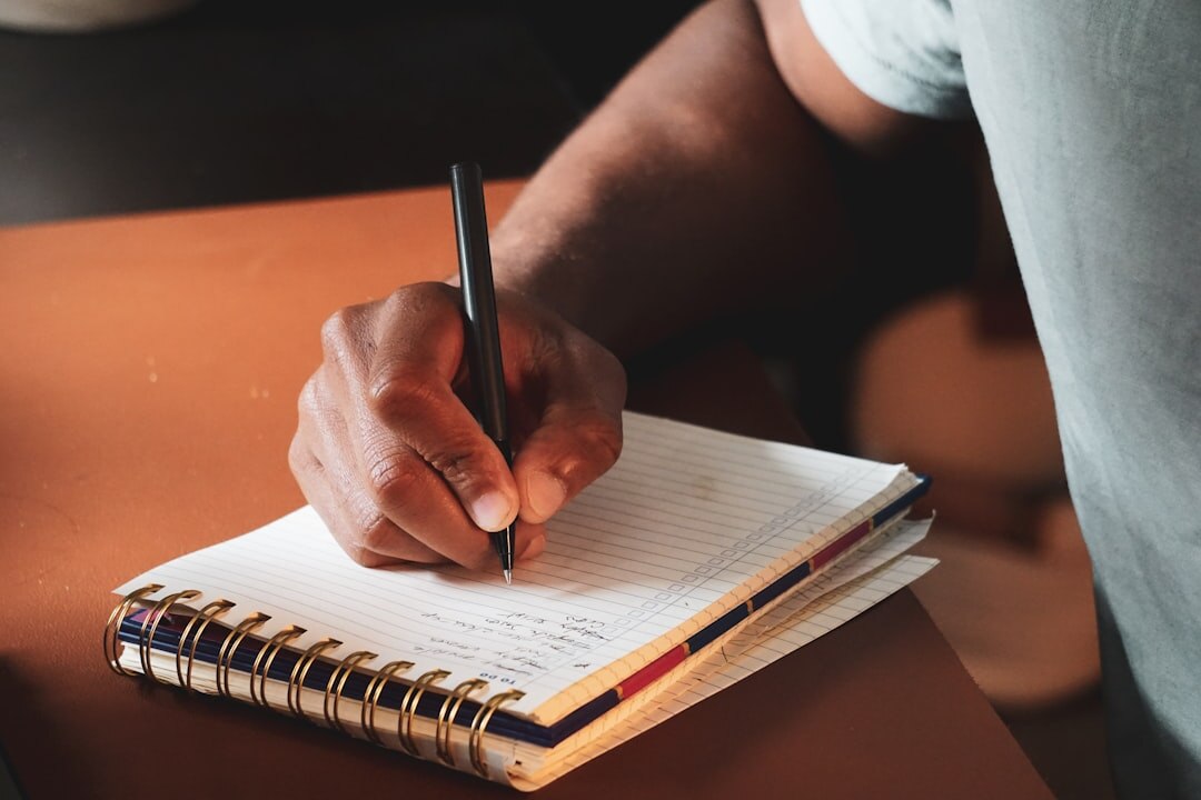 man writing notes